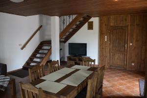 a dining room with a table and a television at Dom na Mazurach in Rydzewo