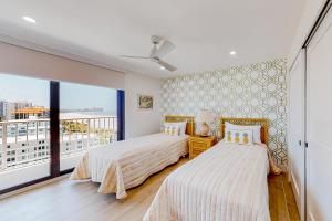 two beds in a room with a balcony at Bird of Paradise in Marco Island +42 photos