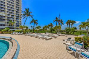 a resort with chairs and a pool and palm trees at Bird of Paradise in Marco Island