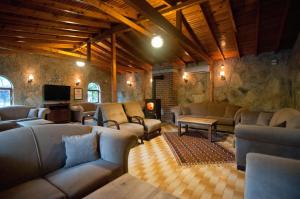 a large living room with couches and a tv at Fener Motel in Şile