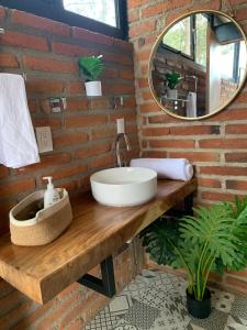 a bathroom with a sink and a mirror on a wooden table at Tres Lunas Domo in Mazamitla