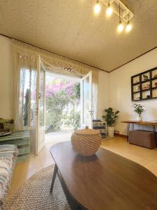 a living room with a table and a large window at Hat De homestay in Xuan An