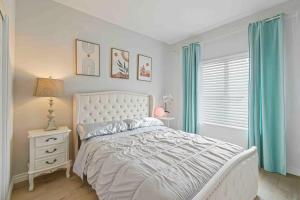 a bedroom with a white bed and a window at Beautiful 3B2B home with piano in Pasadena Oldtown in Pasadena