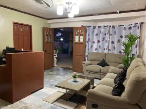 a living room with two couches and a table at Dreamcatcher Hostel in Moalboal