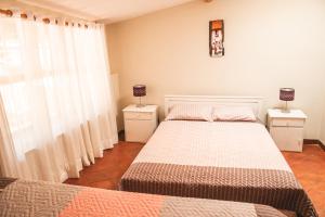 a bedroom with two beds and two night stands at Finca San Antonio De Shudal in Cajamarca
