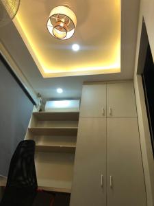 a ceiling with a light and stairs in a room at Comfy Room With Single Sized Bed, Study Space, Closet, and WiFi in Manila