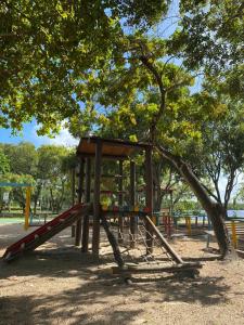 a playground with a slide in a park at Casa amarela in Campos +24 photos