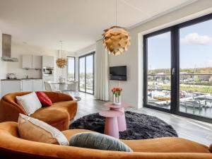 a living room with a couch and a table at Apartment Kamperland with Harbour View in Kamperland
