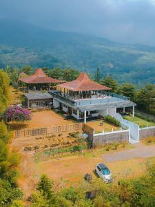 an aerial view of a house with a car parked in front at De Summit Villa & View in Puncak