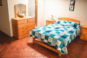 a bedroom with a bed and a dresser and a mirror at Finca San Antonio De Shudal in Cajamarca