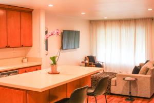 a kitchen and living room with a table and chairs at Conveniently located 2bd-LAX-Sofi Stadium-Space X in Inglewood