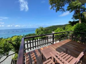 a balcony with a view of the ocean at Chintakiri Resort in Koh Tao