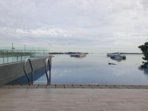 a view of a body of water with boats in it at CozyHomes at One Residence Batam in Batam Center