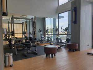 a gym with treadmills and exercise equipment in a building at CozyHomes at One Residence Batam in Batam Center