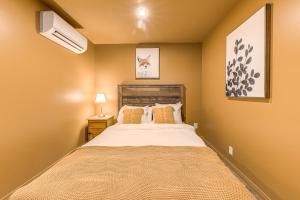 a bedroom with a large bed with a white bedspread at North House - Two bedroom Escape in the Heart of Old Quebec in Quebec City