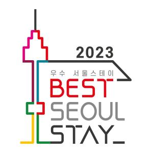 a sign with the words best slow stay and a building at Puzzlestay House in Seoul