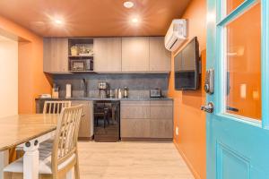 a kitchen with a table and a tv in a room at North House - Quebec City 2 Bedroom Treasure in Quebec City