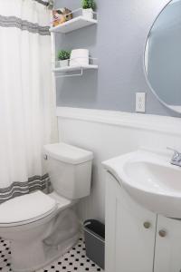 a bathroom with a white toilet and a sink at Luxury Studio Suite close to Tampa Airport in Tampa