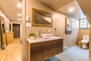 a bathroom with a sink and a toilet at St. Ursule Two-Storey Oasis in Quebec City