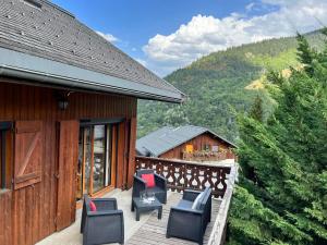 a deck with chairs on a house with a view at Chalet Méribel, 5 pièces, 8 personnes - FR-1-688-57 in Méribel
