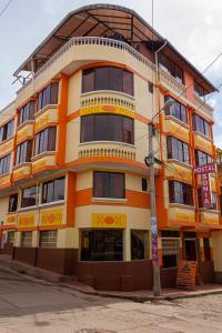 an orange and white building on the corner of a street at Hostal Sonia in Copacabana