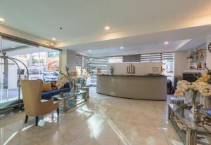 a lobby with a reception desk and a car dealership at Hotel One in Cebu City