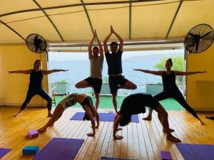 een groep mensen die yoga doen in een kamer bij Rosys Little Village in Skala