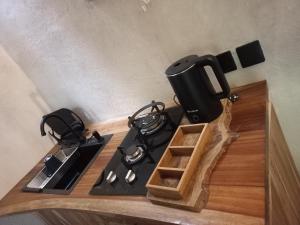 a kitchen with a stove with a tea pot on it at Reureuh Cabin in Batukaras