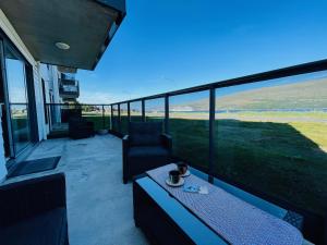 a patio with a table and chairs on a balcony at Dream View apartment in Akureyri