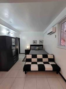 a bedroom with a black and white bed in it at Chalet Belizomi Tropical Villas Studio Villa #3 in Gros Islet