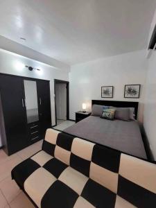 a bedroom with a black and white bed and a mirror at Chalet Belizomi Tropical Villas Studio Villa #3 in Gros Islet