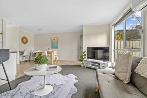 a living room with a couch and a table at Stylish and Spacious Launceston Villa + Free Wifi in Launceston