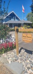 a sign in front of a house with a house at The Hazelhouse in Chilliwack