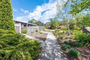 a garden with a walkway in front of a house at Stylish and Spacious Launceston Villa + Free Wifi in Launceston