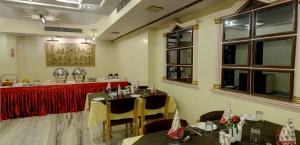 a dining room with two tables and a bar at KANCHAN DEEP in Jaipur +17 photos