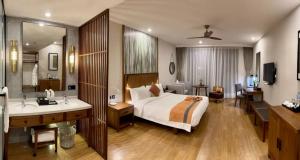 1 dormitorio con 1 cama y baño con lavamanos en 七星海快乐主屋度假酒店 en Kaoh Sdach