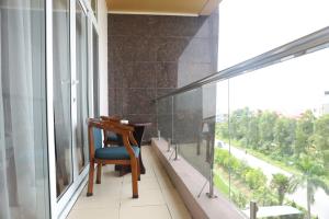 a chair sitting in a room with a large window at J&C HOTEL in Bắc Ninh