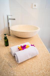 a couple of towels on a counter with a sink at The babakan accommodations in Sidemen