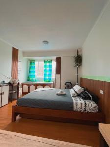 a bedroom with a bed and a desk in it at Albergo Condotel - AB Enterprise in Baguio