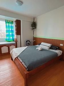 a bedroom with a large bed in a room at Albergo Condotel - AB Enterprise in Baguio