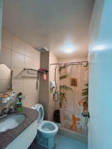 a bathroom with a toilet and a sink and a shower at Albergo Condotel - AB Enterprise in Baguio +11 photos