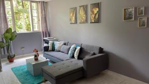 a living room with a gray couch and a window at Golden Meadows Oasis in Golden Spring