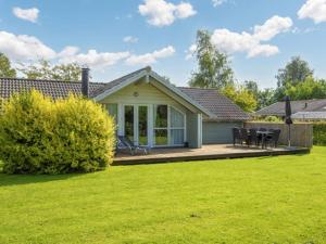 a house with a patio and a lawn at 8 person holiday home in Sydals-By Traum in Neder Lysabild