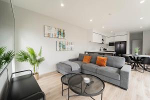 a living room with a couch and a table at Sunnyhills Viewside Town House in Auckland