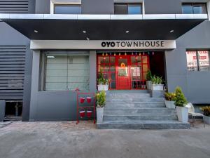 a front entrance to a town house with a red door at Townhouse Hadapsar Near Amanora Mall in Pune