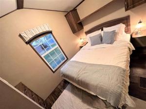 a bedroom with a large bed and a window at Resort near wineries, river, trails! Large Pool! in Niagara-on-the-Lake