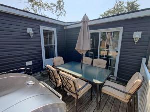 a patio with a table and chairs and an umbrella at Resort near wineries, river, trails! Large Pool! in Niagara on the Lake