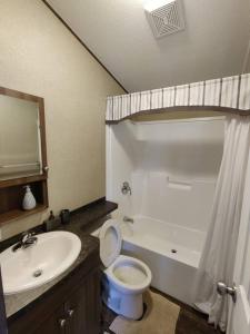 a bathroom with a sink and a toilet and a tub at Resort near wineries, river, trails! Large Pool! in Niagara-on-the-Lake
