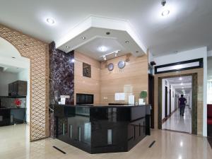 a lobby with a black counter in a building at Cove Taman in Jakarta