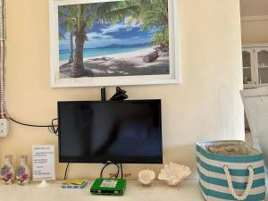a flat screen tv sitting on top of a desk at Sunrise Guest House in Taytay